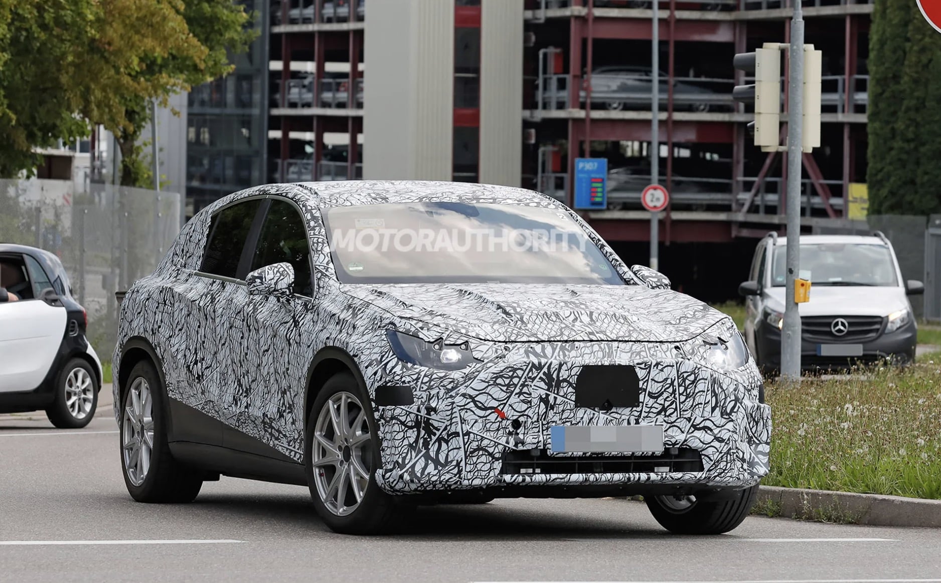 All-electric Mercedes-Benz GLC in camo wrap.