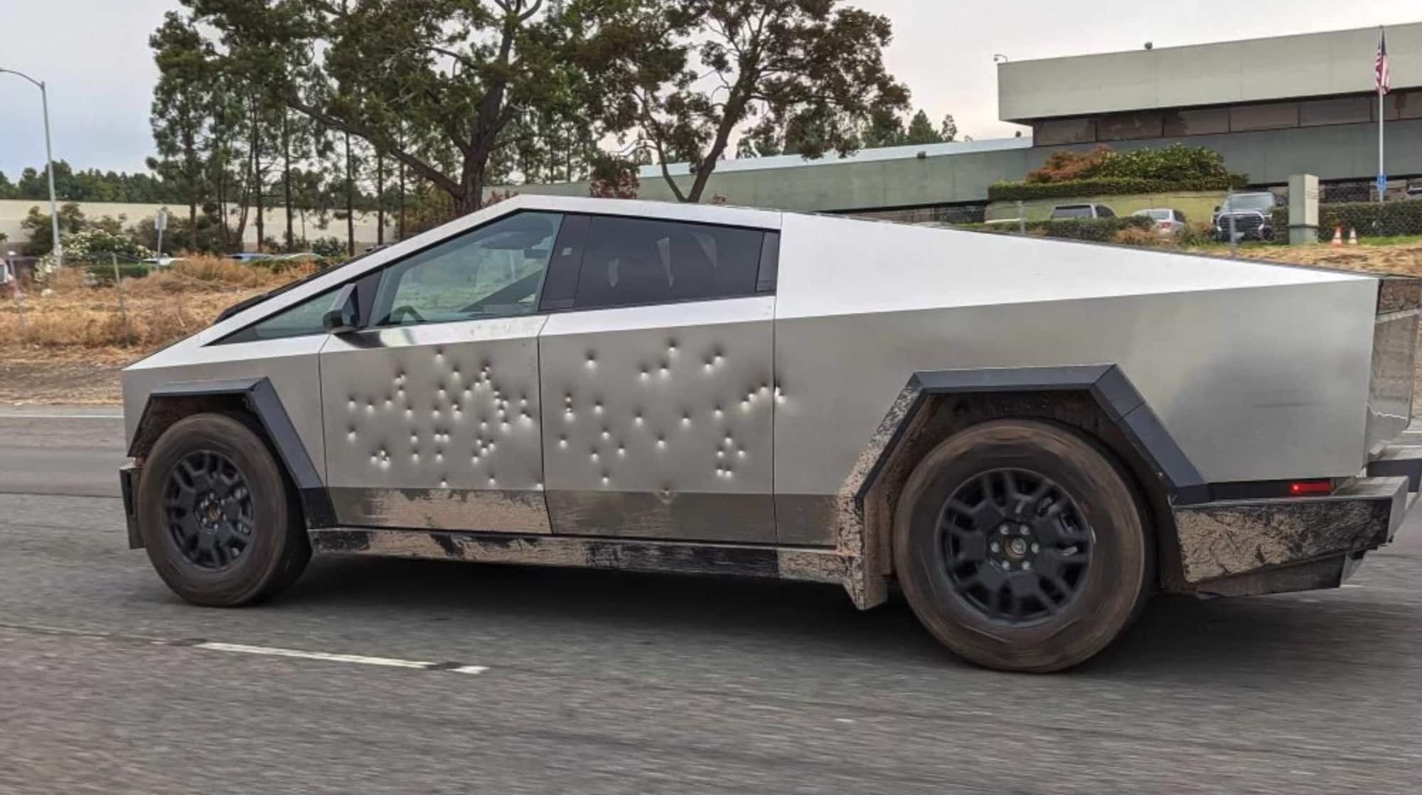 This photo shows the Tesla Cybertruck riddled with bullet holes in the side. The electric truck was shot at with a Tommy Gun according to Elon Musk.