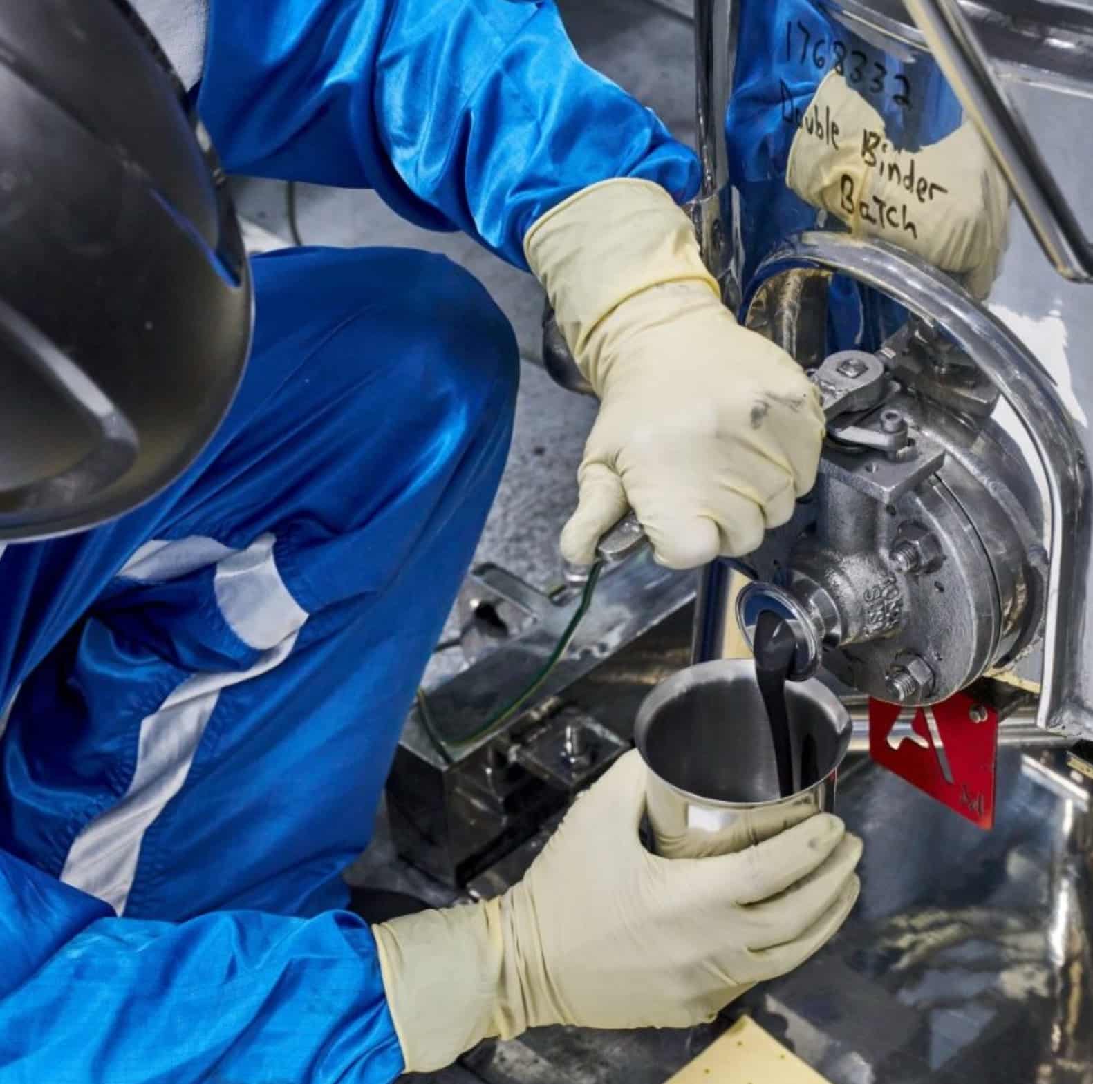 A battery technician at GM’s Wallace Battery Cell Innovation Center collects a sample of chemical slurry. Photo credit: Steve Fecht for General Motors