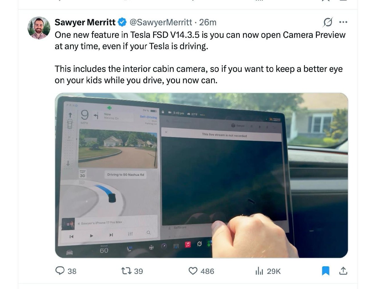 Tesla center touchscreen showing FSD navigation alongside a live camera preview window while the car is driving