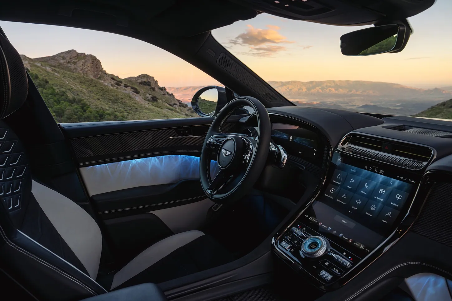 Bentley Torcal dashboard with a curved driver display, a large center touchscreen and physical knurled controls on the console