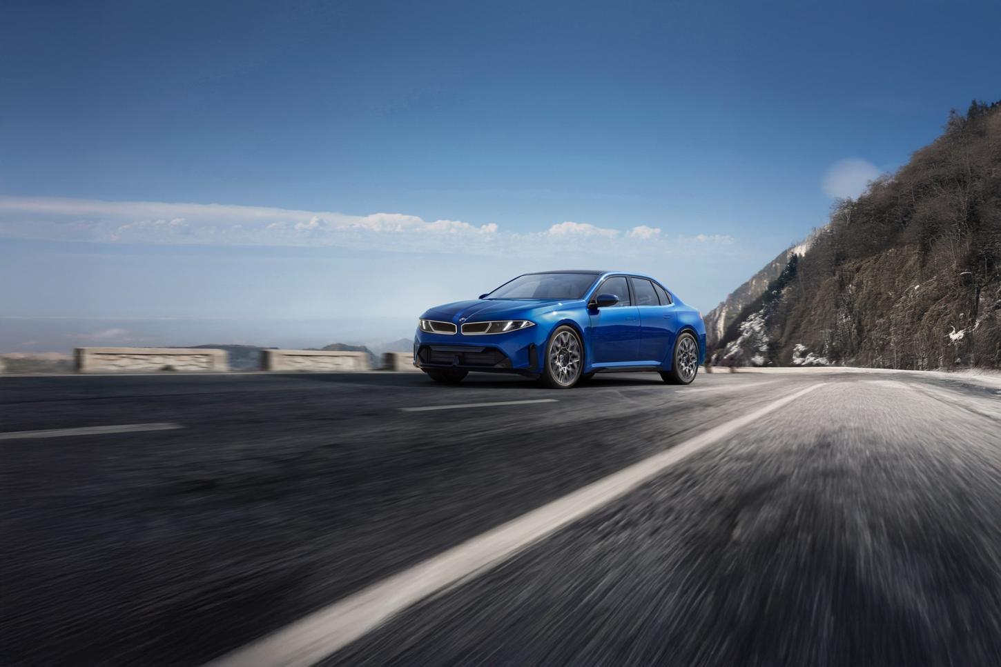 Blue BMW i3 sedan driving along a mountain highway