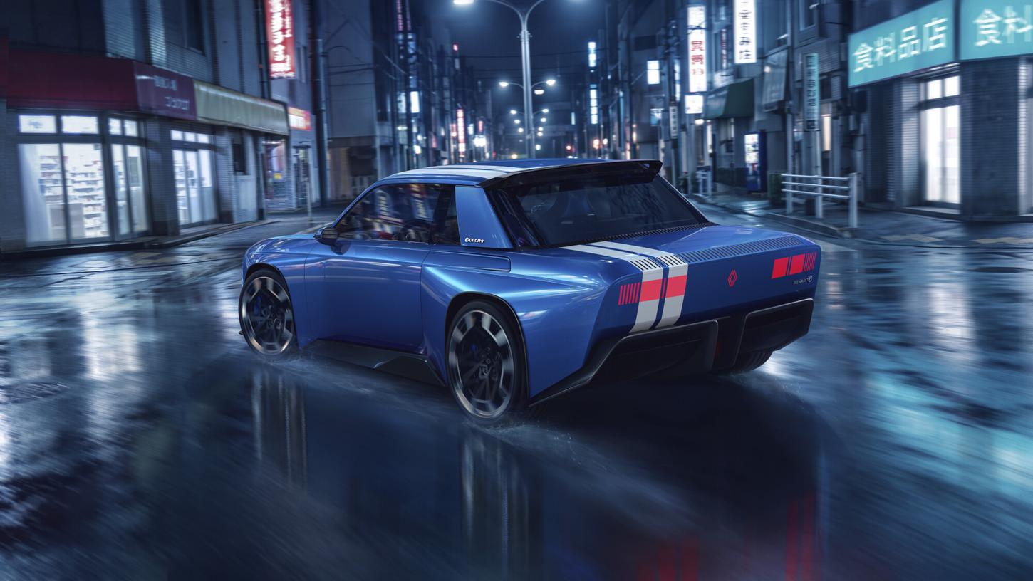 Rear view of the blue Renault 8 Gordini Concept with white stripes and red rear lights on a city street at night