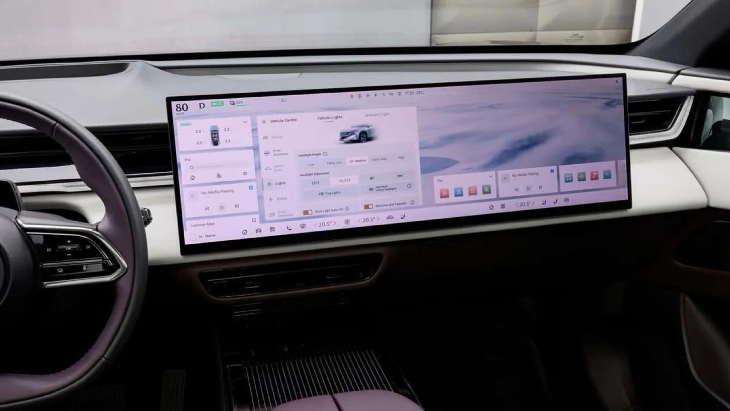 Dashboard of a Mazda CX-6e with a 26.45-inch widescreen display showing the Vehicle Centre lighting menu above a brown leather console