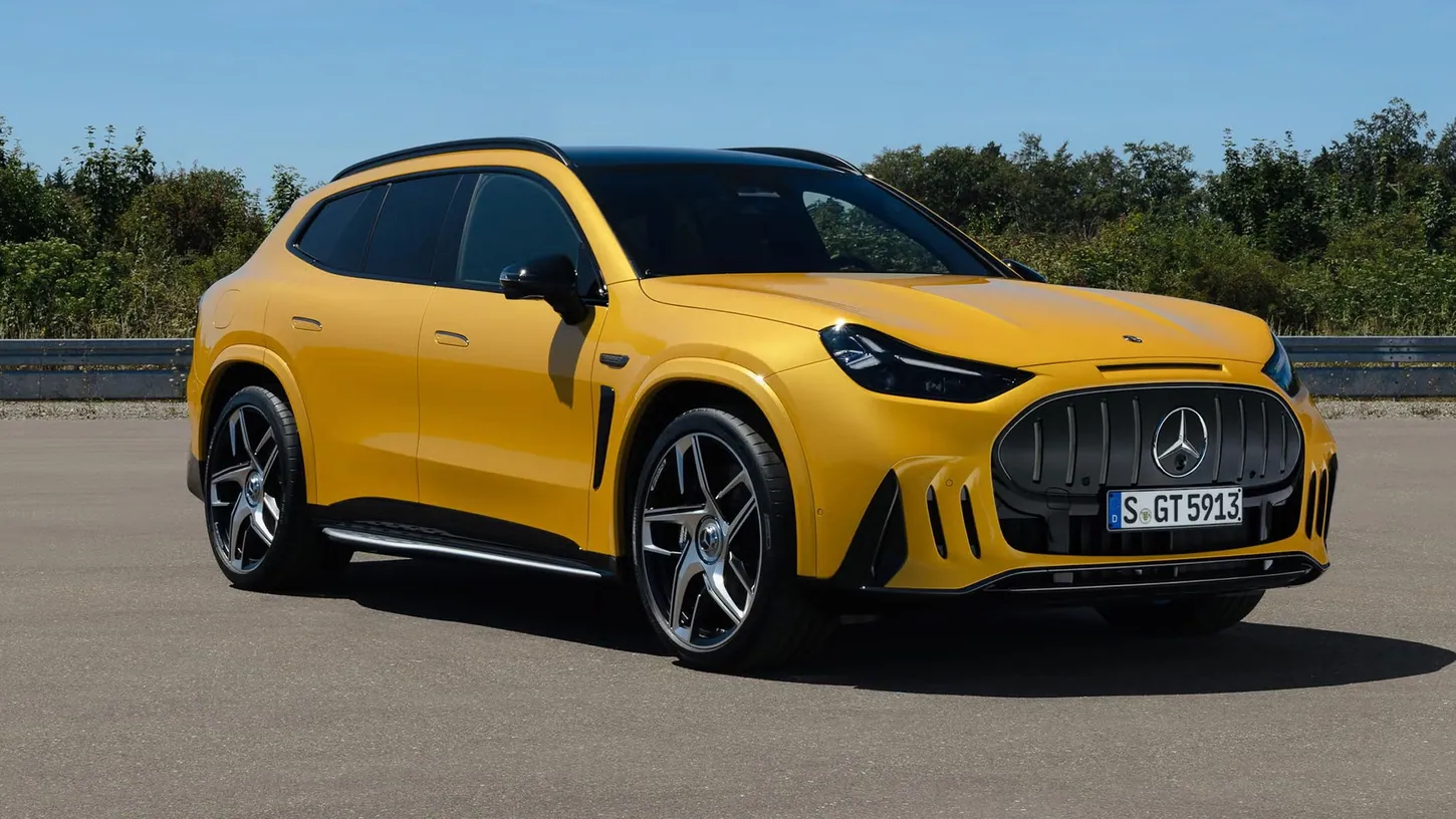 Yellow Mercedes-AMG GT 63 SUV parked on a test track, seen from the front three-quarter angle with its vertical-slat grille