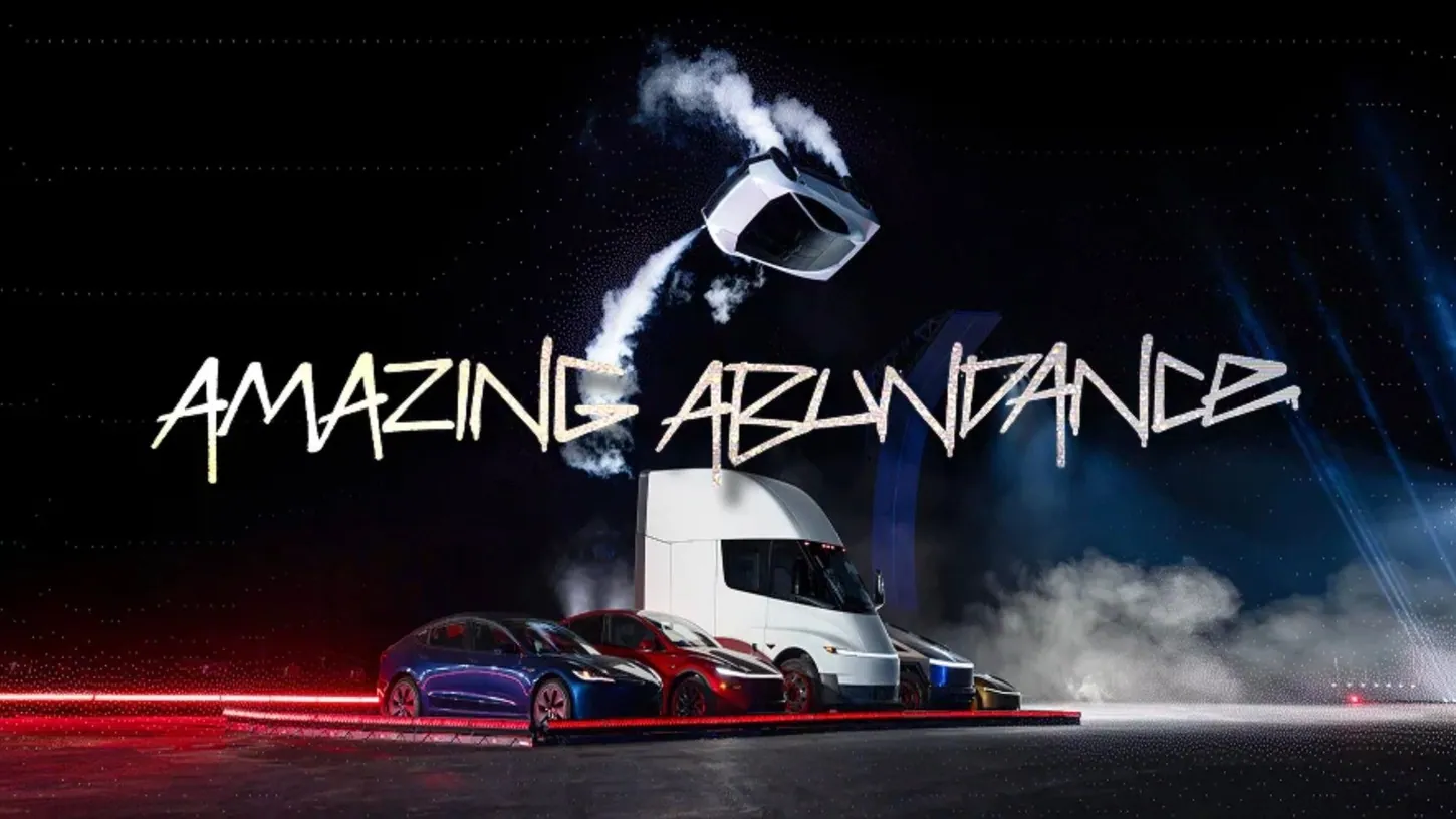 White Tesla Roadster upside down in midair trailing thruster vapor above a Model 3, Model Y, Semi, Cybertruck and Cybercab, with the words Amazing Abundance across the night sky