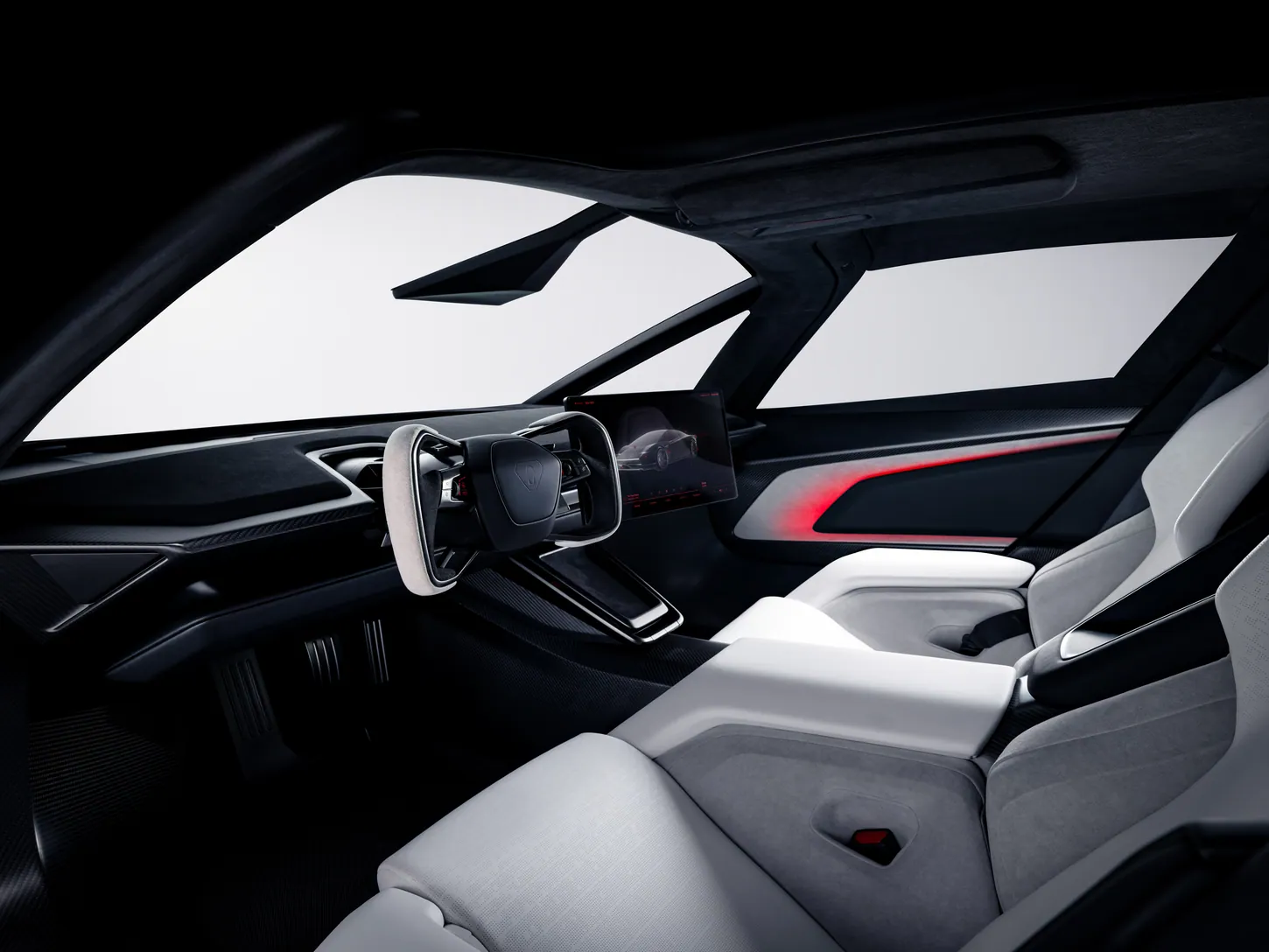 Tesla Roadster cockpit seen from the passenger side, with the yoke, a dash-mounted screen, two pedals in the footwell and white seats