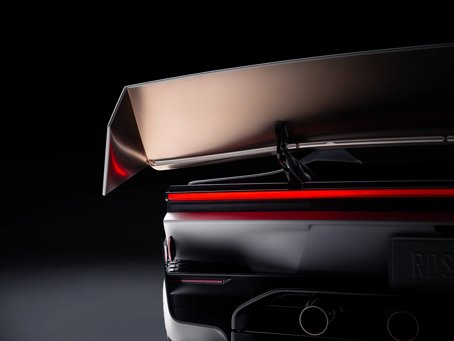 Close-up of the Tesla Roadster rear wing raised on a single black support above the red full-width taillight