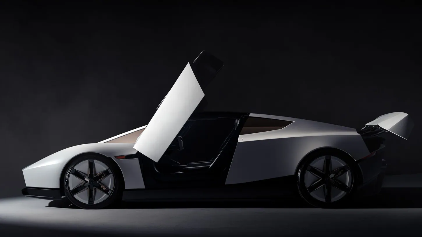 White Tesla Roadster in side profile in a dark studio, its driver door raised upward and its rear wing lifted