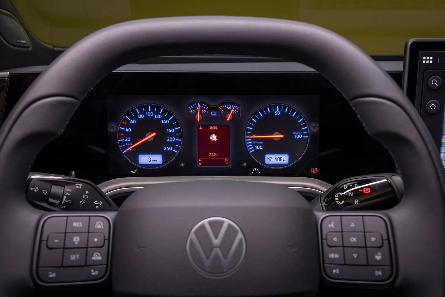 The ID. Tiguan driver display in Retro mode showing blue and red Golf IV style round gauges behind a steering wheel with physical buttons