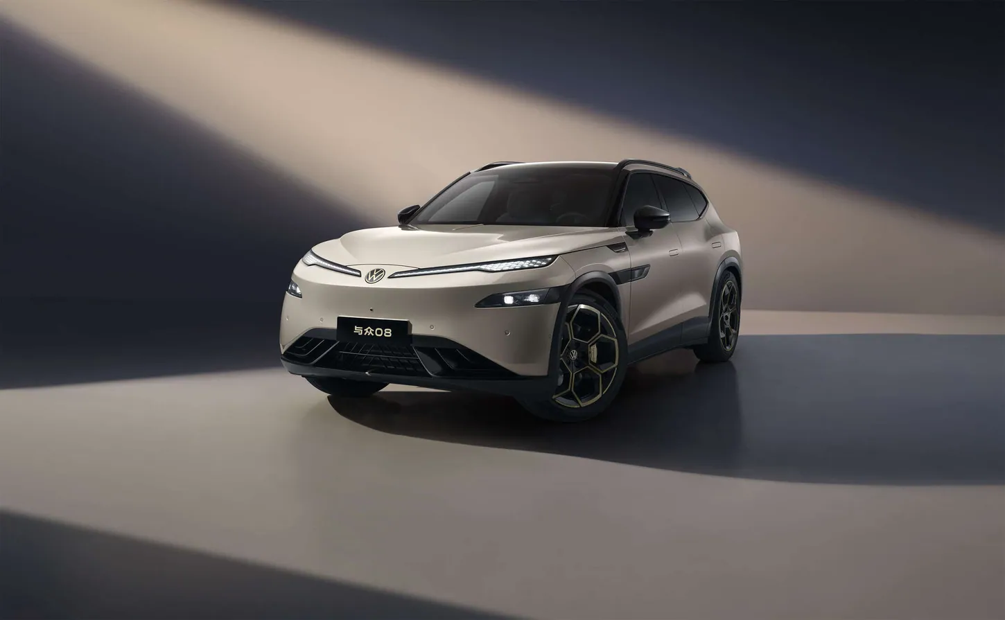 Beige Volkswagen ID. UNYX 08 electric SUV with gold-accented wheels in a studio with diagonal light